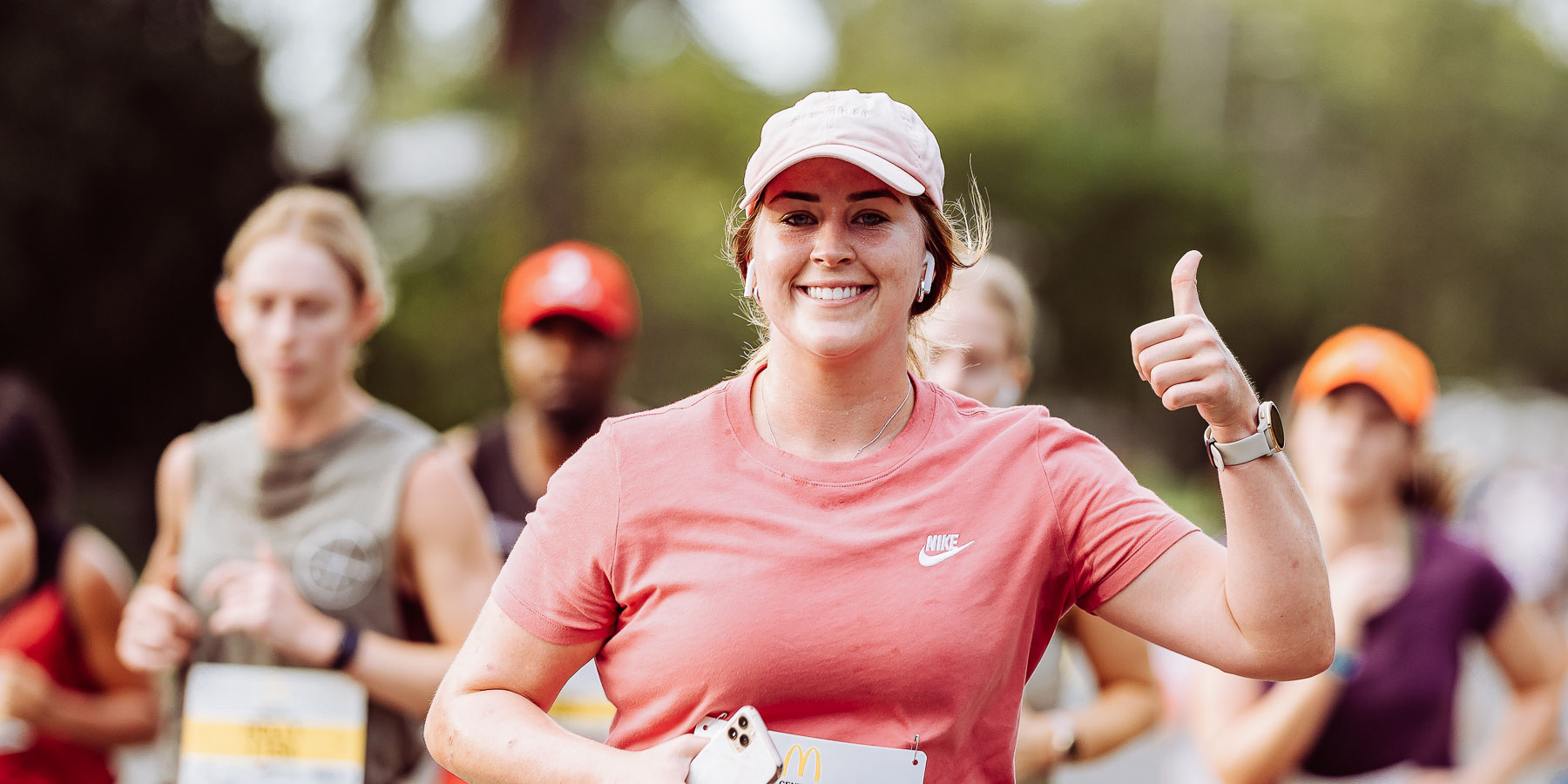 Woman giving thumbs up while running in charity run in Rockhampton
